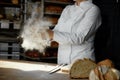 Closeup female chef hands clapping in cloud of powdery flour over table Royalty Free Stock Photo