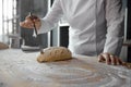 Closeup female chef hands making dough ornament decorating bread bun Royalty Free Stock Photo
