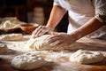 closeup of a female chef\'s hands making dough on the table in a kitchen flooded with sunlight