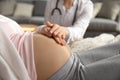 Closeup of female doctor support help young pregnant woman patient