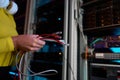 Closeup female IT engineer hands holding internet cables