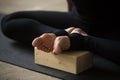 Closeup of female feet in Butterfly pose with block, studio