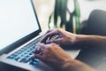 Closeup female freelancer sitting front open laptop computer with blank screen blue monitor, young business woman work on notebook