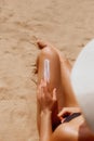 Closeup on female Hand applying solar  sun cream  on Leg. Skincare. Sun protection Royalty Free Stock Photo