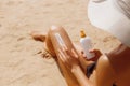 Closeup on female Hand applying solar sun cream on Leg. Skincare. Sun protection. Woman smear sunscreen moisturizing lotion on her Royalty Free Stock Photo