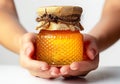 Closeup of female hand with a glass jar of honey. AI generated Royalty Free Stock Photo