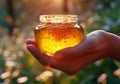 Closeup of female hand with a glass jar of honey. AI generated Royalty Free Stock Photo