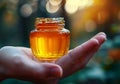 Closeup of female hand with a glass jar of honey. AI generated Royalty Free Stock Photo