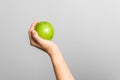 Closeup female hand holding green apple, healthy life and food. diet concept Royalty Free Stock Photo