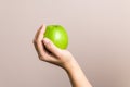 Closeup female hand holding green apple, healthy life and food. diet concept Royalty Free Stock Photo