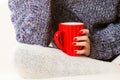 Closeup female hand holding red mug hot drink Royalty Free Stock Photo