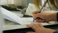 Closeup of a female hand writing on an blank notebook with a pen. Close-up of a female hand writing on an blank notebook Royalty Free Stock Photo