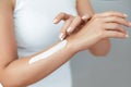 Closeup of female hands applying hand cream.Hand Skin Care. Women use body lotion on your arms. Beauty And Body Care Royalty Free Stock Photo