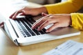 Closeup of a female hands busy typing on a laptop