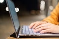 Closeup of female hands on a computer touchpad. Freelancer remotely works on a laptop in the fresh air. A woman is Royalty Free Stock Photo