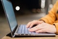 Closeup of female hands on a computer touchpad. Freelancer remotely works on a laptop in the fresh air. A woman is Royalty Free Stock Photo