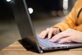 Closeup of female hands on a computer touchpad. Freelancer remotely works on a laptop in the fresh air. A woman is Royalty Free Stock Photo