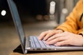 Closeup of female hands on a computer touchpad. Freelancer remotely works on a laptop in the fresh air. A woman is Royalty Free Stock Photo