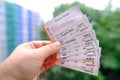 Closeup female hands hold many tickets, monthly travel passes in germany for all modes of public transport, travel concept for