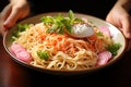 Closeup of female hands holding a bowl with udon noodles and boiled egg Royalty Free Stock Photo