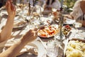 Closeup of female hands holding glasses of champagne. Making a celebratory toast with sparkling wine Royalty Free Stock Photo