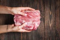 Closeup of female hands holding meat piece