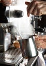 Closeup female hands are making coffee using professional metal machine in cafe Royalty Free Stock Photo