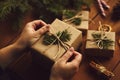 Female hands packing Christmas gifts on table Royalty Free Stock Photo