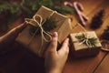 Female hands packing Christmas gifts on table