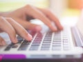 Closeup female hands typing on laptop keyboard. Royalty Free Stock Photo