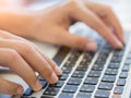Closeup female hands typing on laptop keyboard. Royalty Free Stock Photo