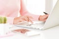 Closeup female hands typing on laptop keyboard.