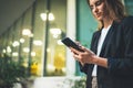 Closeup of female hands using modern smartphone device near urban office, focus on cellphone, social network and communication Royalty Free Stock Photo