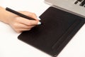 Closeup of female hands working on black graphic tablet, designer drawing sketch using pen stylus to paint Royalty Free Stock Photo