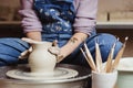 Closeup of female hands working on the pottery wheel for making a pot Royalty Free Stock Photo