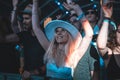 Closeup of a female with a hat enjoying during Electric Love Festival, crowd blurred background