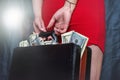 Closeup of female holding briefcase with money as bribery