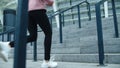 Closeup female legs running up stairs outdoor. Close up sport woman jogging