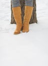 Closeup on female legs in winter boots on snow Royalty Free Stock Photo