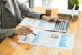 Closeup, Female manager checking business sale data on papers