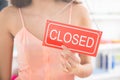 Owner Holding Closed Sign In Clothing Store Royalty Free Stock Photo