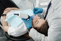 Closeup of female patient in dental chair on a procedure of intraoral digital scan of her teeth