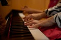 Closeup female pianist hands creating the rhythm of melody, touching white and black keys of piano while playing