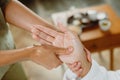 Female receiving hand massage at health spa salon.