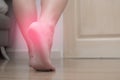 Closeup of female right foot heel pain, with red spot, plantar fasciitis Royalty Free Stock Photo