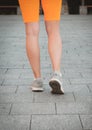 Closeup female running shoes. Fitness woman getting ready for run, sport runner ready for jogging outdoors in fashion sportswear Royalty Free Stock Photo