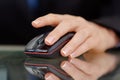 Closeup of a female's hand working on computer mouse Royalty Free Stock Photo