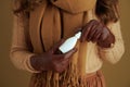 Closeup on female in scarf on bronze background