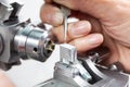 Closeup of a female scientist placing a sample on a transmission electron microscopy grid