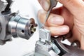 Closeup of a female scientist placing a sample on a transmission electron microscopy grid